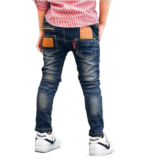 Young boy wearing blue stretch denim pants from Ancient Energy, casual style with comfortable fit and classic five-pocket design.
