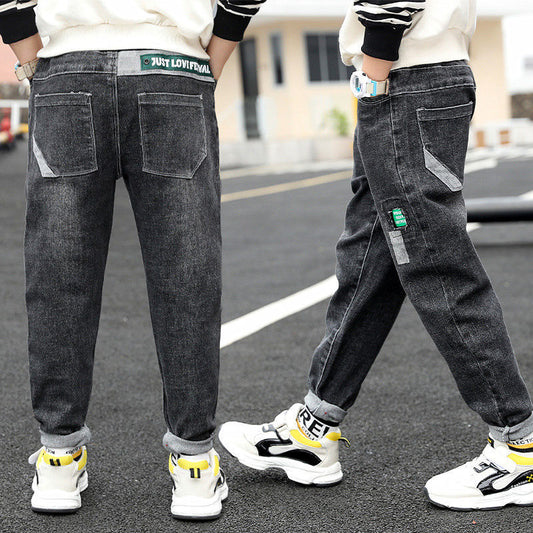 Boy wearing Ancient Energy velvet one-piece jeans for autumn and winter, featuring a cozy, stylish denim design.