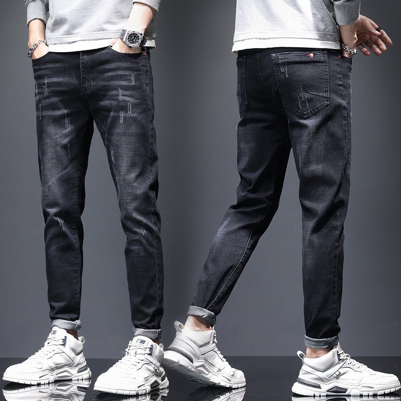Mens ripped denim jeans with cat-whisker scratches from Ancient Energy, showing distressed fabric and stylish design details.