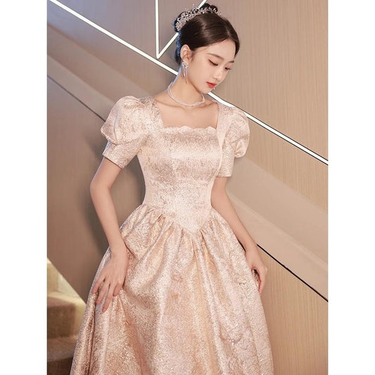 Elegant champagne-colored women evening dress by Ancient Energy, featuring a flowing design and stylish neckline.