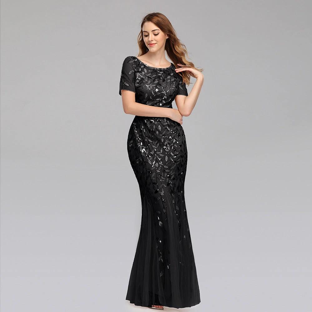 Elegant black evening dress by MANDOTOS featuring a fitted bodice and flowing skirt, perfect for formal occasions.