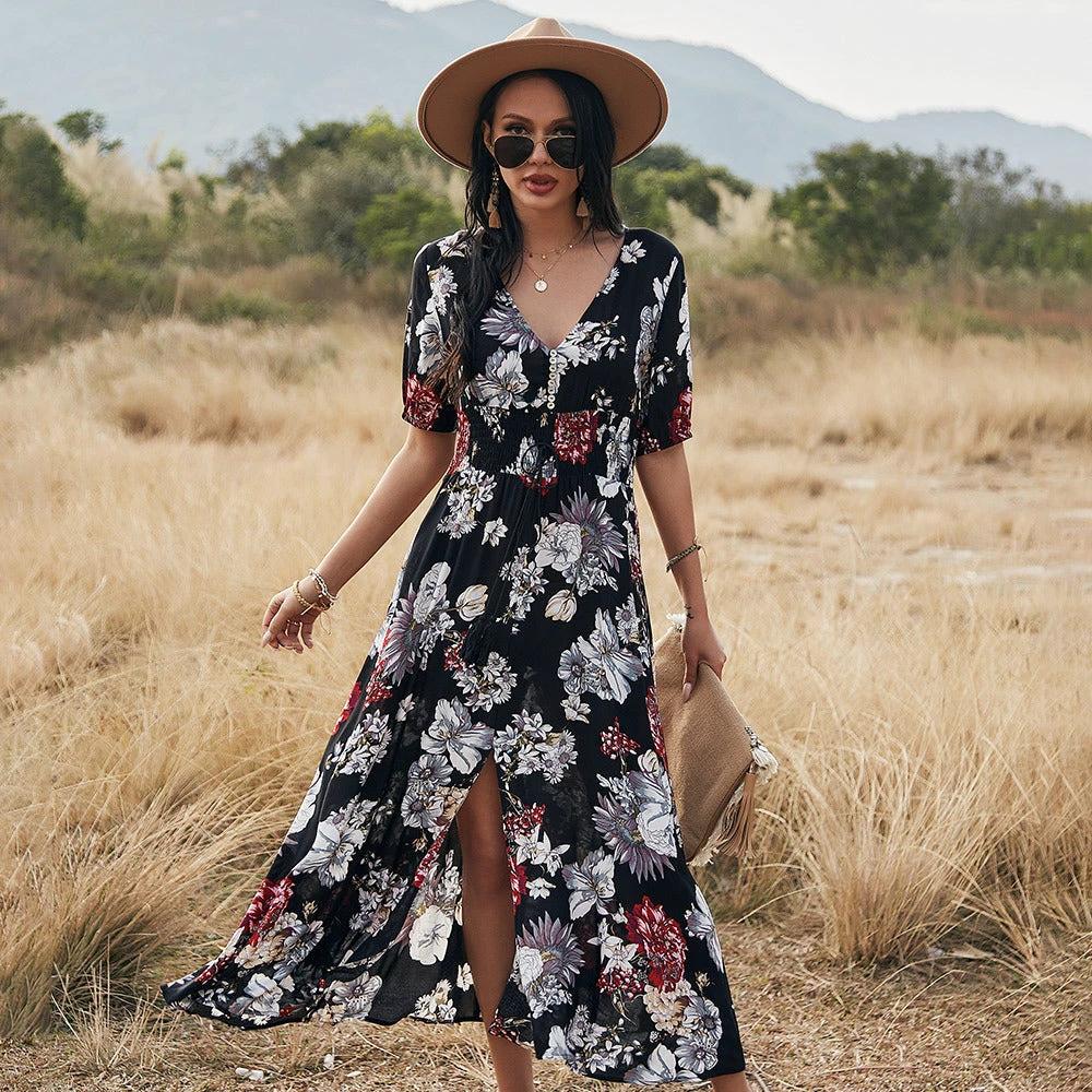 Mandotos floral summer beach dress with V-neck and elastic waist, worn by a woman on the beach in a casual, flowy style.