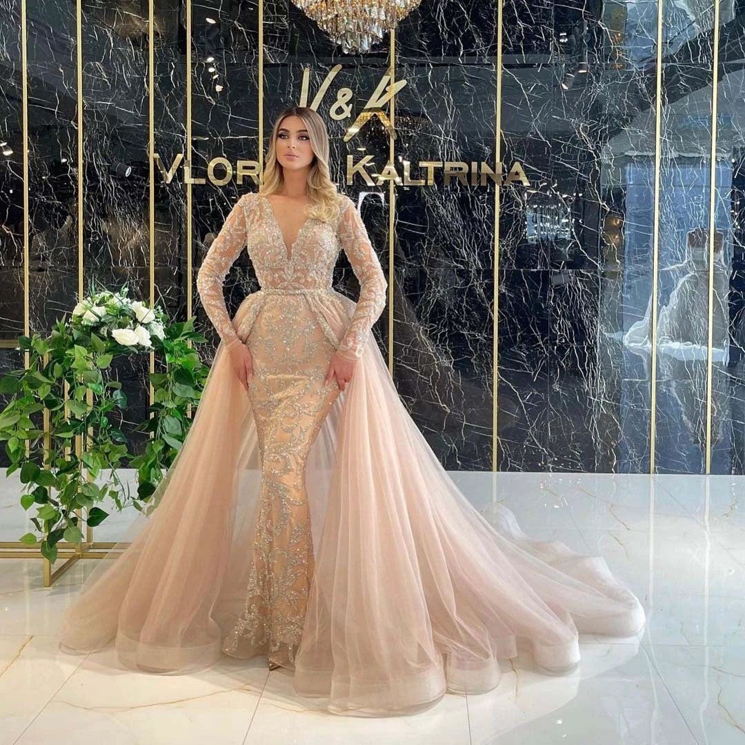 Elegant French style wedding dress with long sleeves and simple design by MANDOTOS, featuring a fitted bodice and flowing skirt.