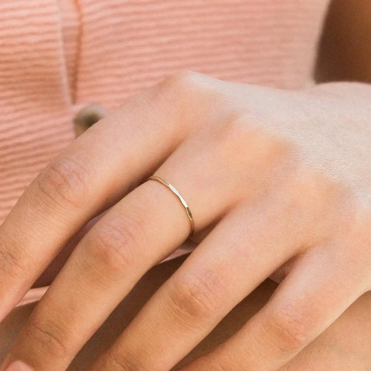 14K gold-filled textured stacking ring from MANDOTOS, featuring a shiny, hammered finish on a sleek band.