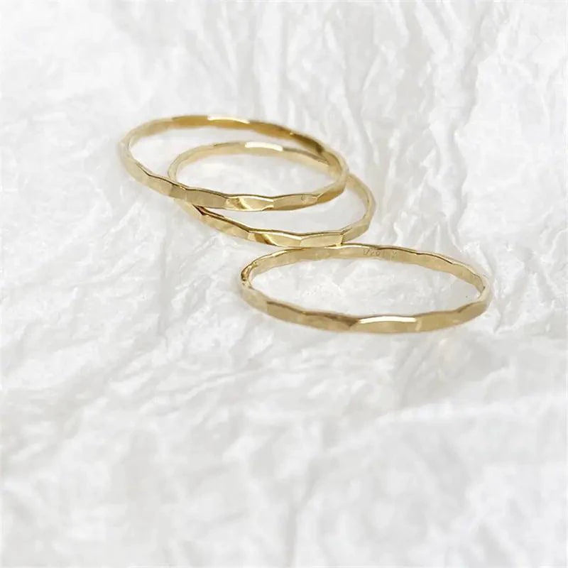 14K gold filled textured stacking ring by MANDOTOS, showcasing a close-up of the detailed, shiny band on a white background.