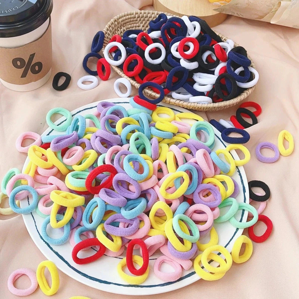 Set of 20/50 kids elastic hair bands by MANDOTOS, colorful sweets-themed scrunchies and hair ties for children’s hair accessories.