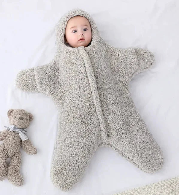 Soft baby quilt by MANDOTOS with pastel colors and cozy fabric, perfect for nursery and stroller comfort.