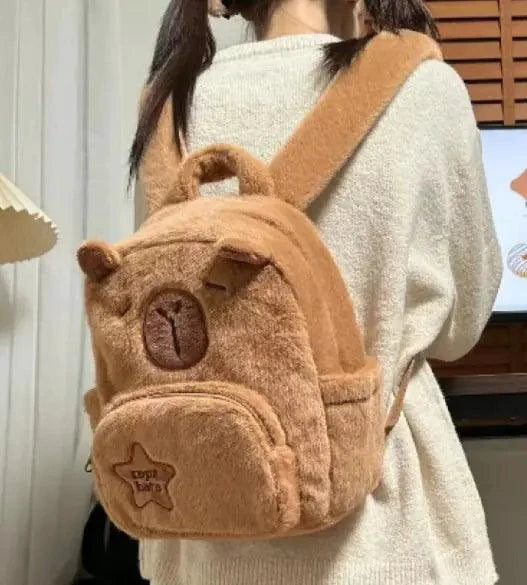 Mandotos Capybara Cuddle Backpack featuring a soft plush design and realistic capybara face for cute, cozy carrying.