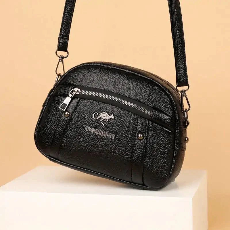 Mandotos chic leather circle purse with a sleek design, featuring a smooth brown leather finish and a compact, stylish shape.