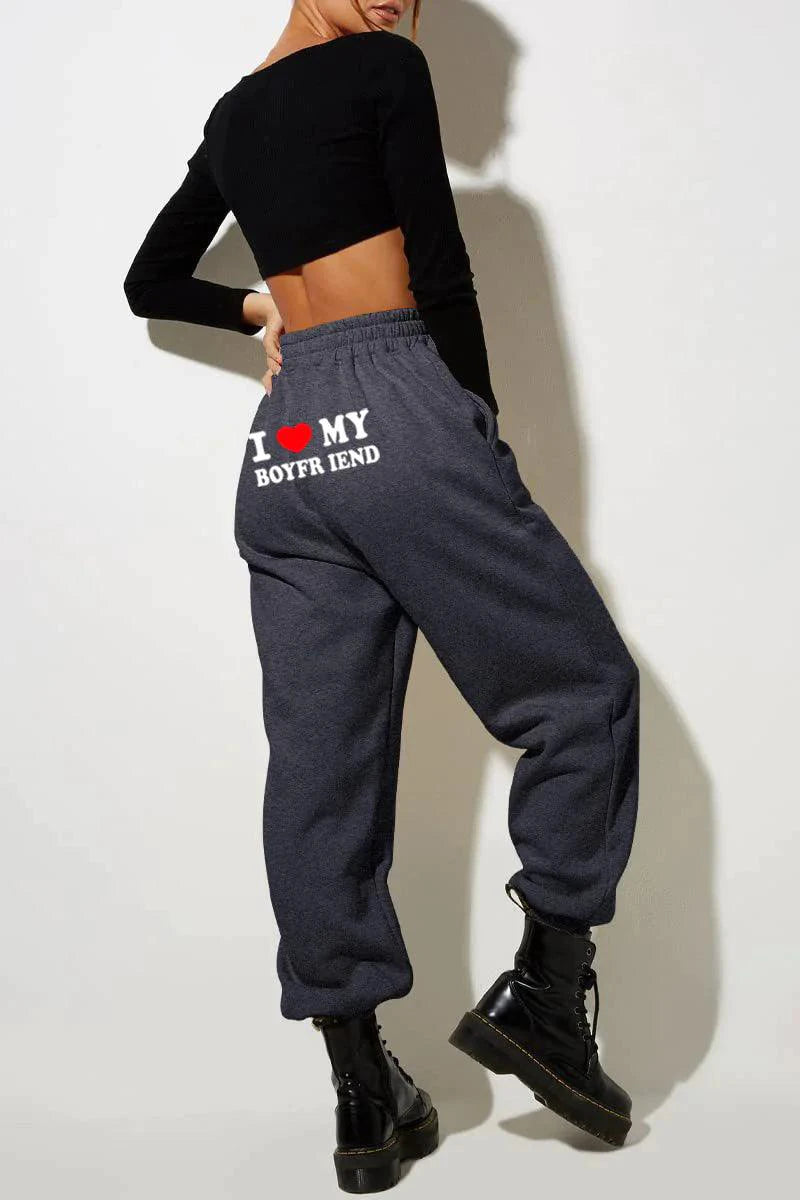 Mandotos chic love print trousers featuring a stylish floral pattern and tailored fit, perfect for casual or semi-formal wear.