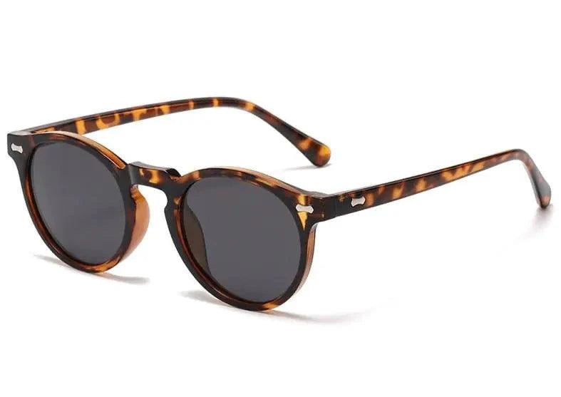 Mandotos chic round UV-block sunglasses with black frames and dark tinted lenses, stylish and protective for sunny days.