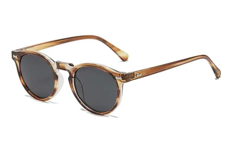 Mandotos chic round UV-block sunglasses with black frames and dark lenses, stylish and protective for sunny days.