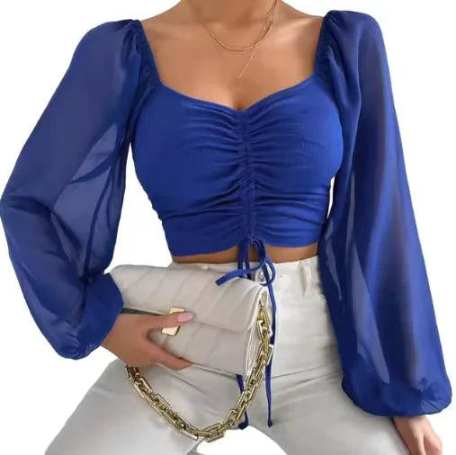 Mandotos chic v-neck crop top with balloon sleeves, stylish and trendy, shown on a model in a casual setting.
