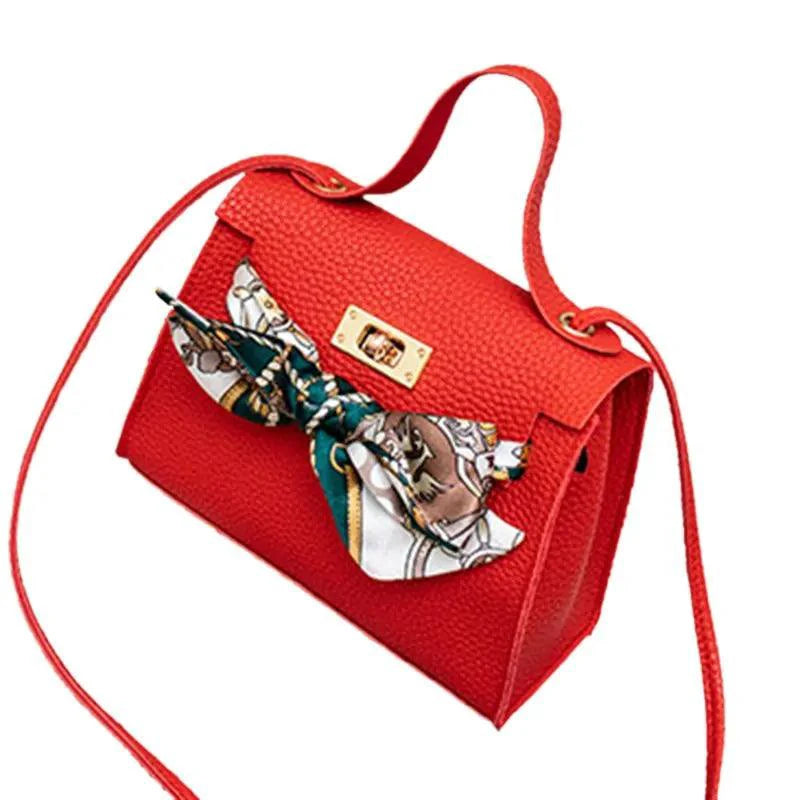 Elegant leather handbag with matching scarf from MANDOTOS, featuring detailed stitching and stylish design.