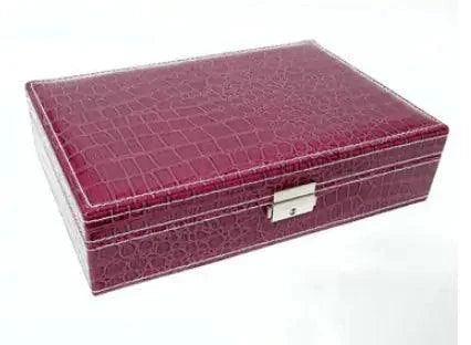 Elegant leather vanity case by MANDOTOS with a structured design and brass hardware, ideal for storing beauty essentials.