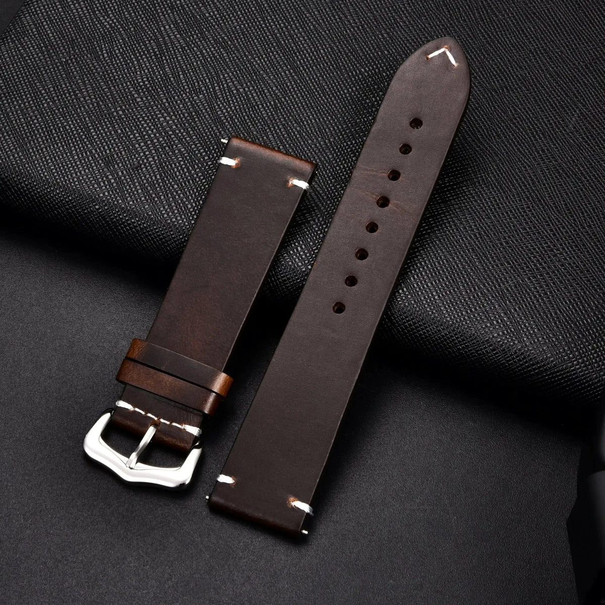 Elegant leather watch band by MANDOTOS, showcasing a high-quality brown strap with detailed stitching on a neutral background.