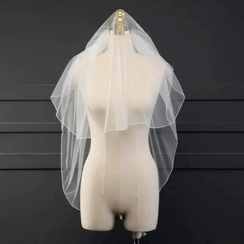 Ethereal double-tiered veil by MANDOTOS featuring delicate lace and airy tulle for a soft, romantic bridal look.