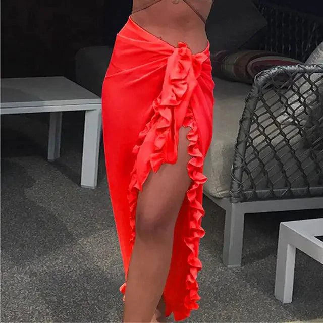 Mandotos GlamourWave chiffon beach wrap draped over a model's shoulders, lightweight and elegant for sunny day beachwear.