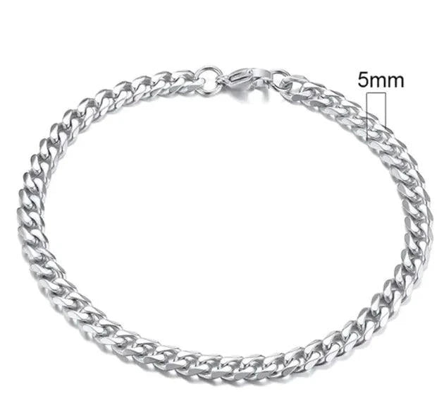 Gold-tone stainless steel Cuban bracelet by MANDOTOS, featuring 3-11mm wide links, displayed on a neutral background.