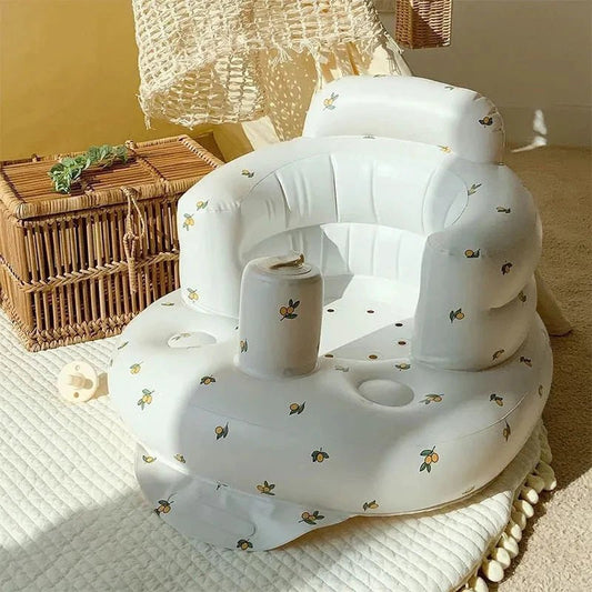 Inflatable baby chair by MANDOTOS designed for dining and bath, featuring a soft, supportive seat with safety valves.