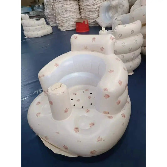 Inflatable baby chair by MANDOTOS designed for dining and bath use, featuring a soft, colorful seat with safety features.