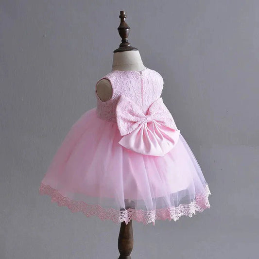 Little Princess gown by MANDOTOS INTERNATIONAL featuring a pink ruffled dress with satin bow, perfect for young princesses.