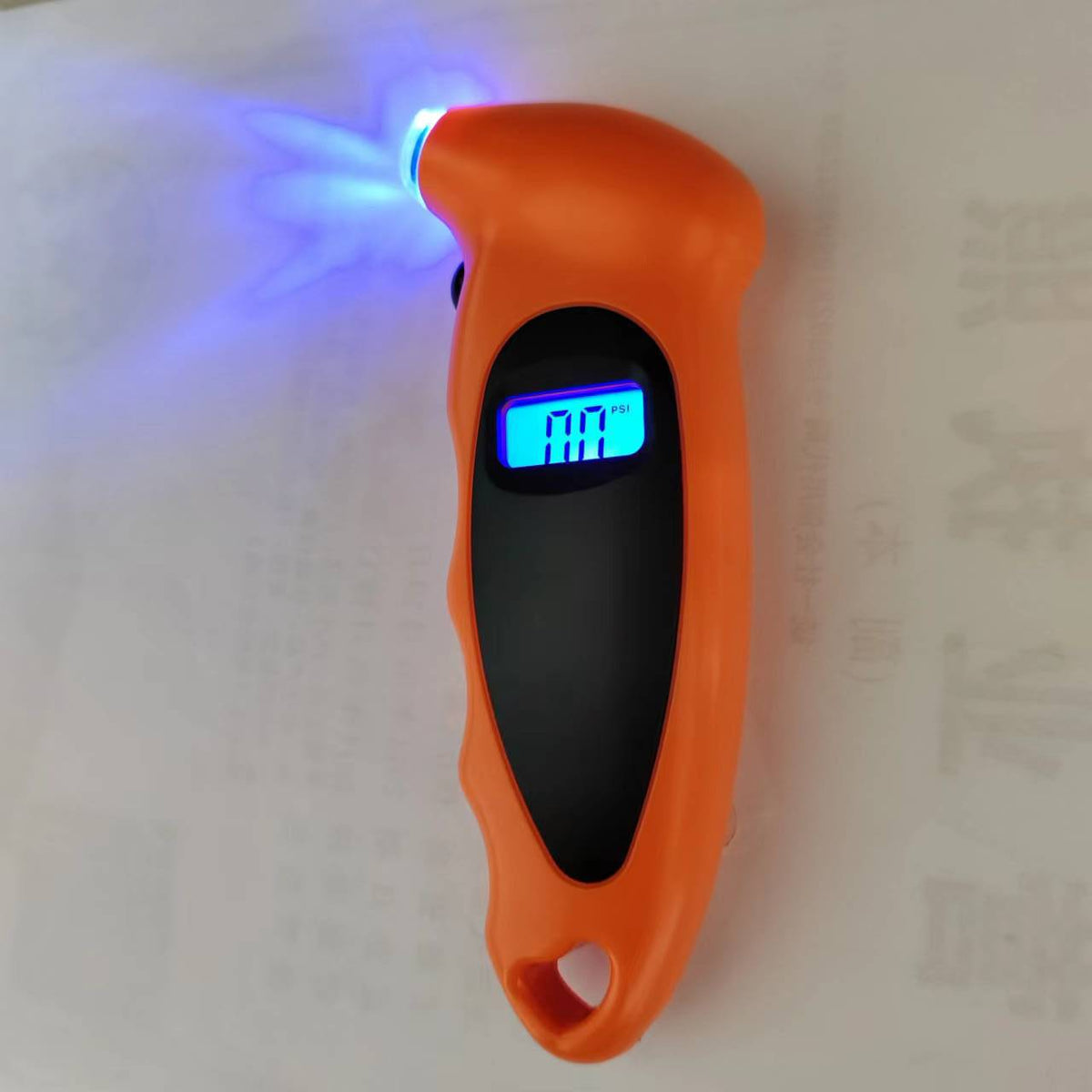 Mandotos International smart tire pressure monitor displaying digital readout on a vehicle's dashboard.