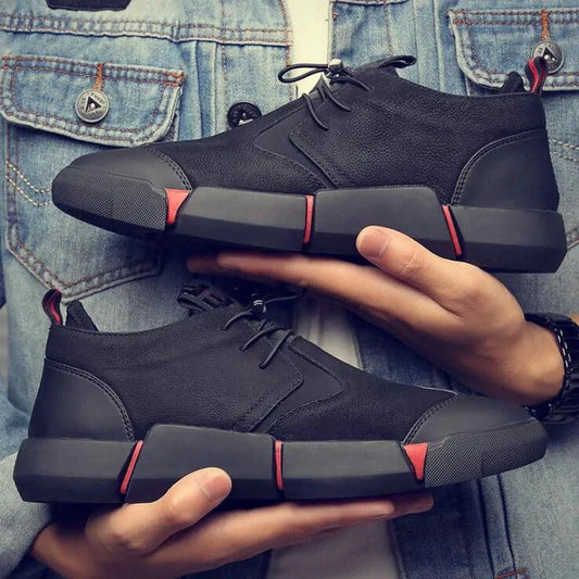 Men's chic leather sneakers by MANDOTOS featuring stylish design, white soles, and sleek black leather material.