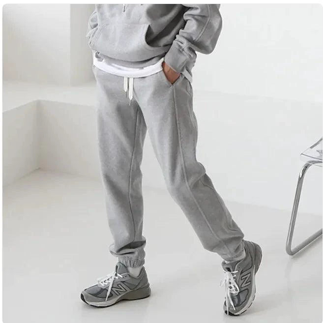 Men's hooded sports sweatshirt by MANDOTOS, showing a comfortable, casual fit in a dark color with front pocket and drawstrings.