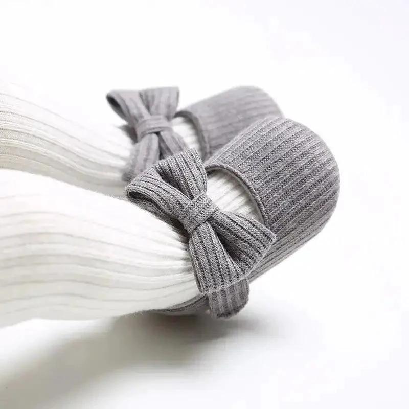 Soft newborn shoes from MANDOTOS with flexible fabric and adorable design, perfect for delicate baby feet.