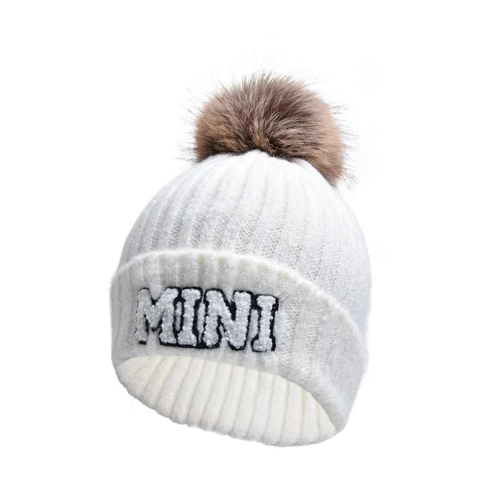 Matching parent-child beanie hats set by MANDOTOS, including three cozy winter knitted caps for mama, papa, and baby.