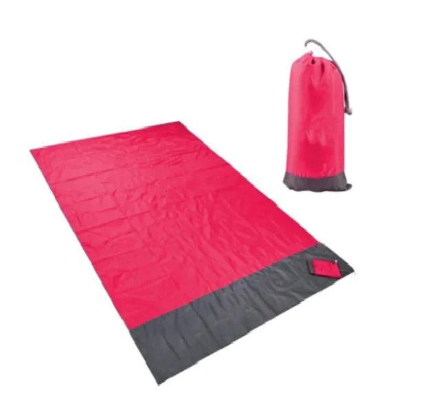 Mandotos sandproof portable beach mat spread out on sandy beach, lightweight and foldable for easy outdoor use