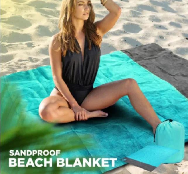 Mandotos sandproof portable beach mat spread on sandy shore, lightweight and easy to carry for outdoor beach relaxation.