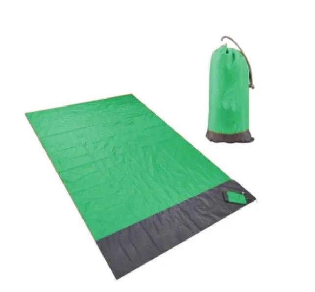 Mandotos sandproof portable beach mat laid out on sandy shore, lightweight and easy to carry for outdoor beach outings.