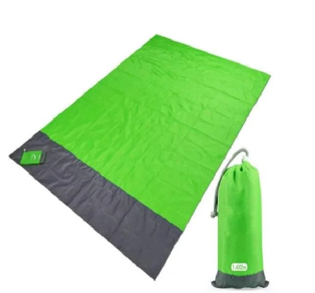 Mandotos sandproof portable beach mat spread on sandy shore, lightweight and foldable for easy beach outings.