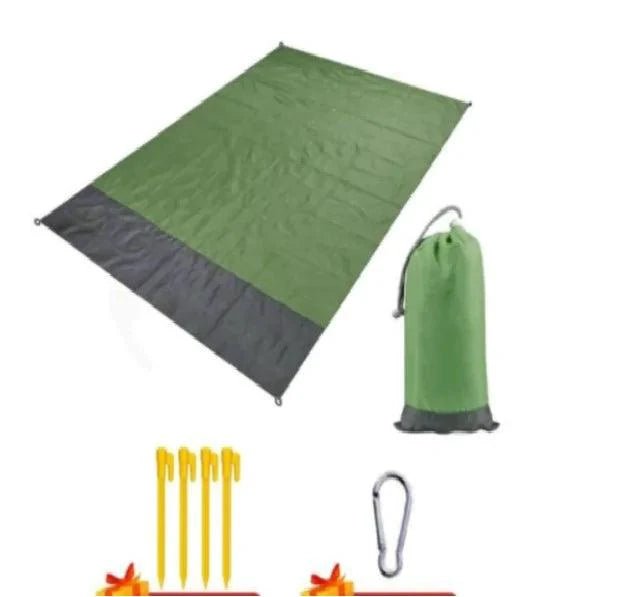 Mandotos sandproof portable beach mat spread out on sandy shore, lightweight and easy to carry for outdoor beach trips.