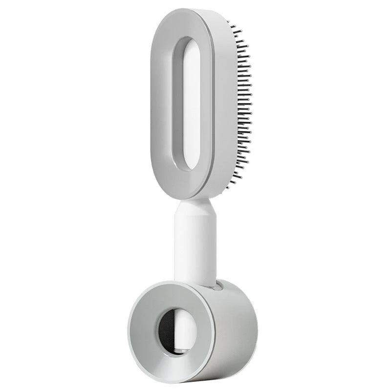 Mandotos self-cleaning hair brush with scalp massage features, showing the brush's bristles and ergonomic handle.