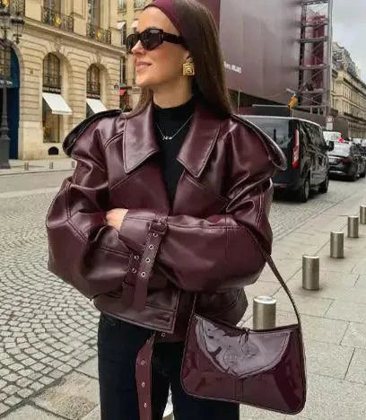 Mandotos sleek matte leather coat featuring a modern design and smooth matte finish, displayed on a mannequin.