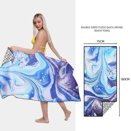 Colorful patterned SwiftDry beach towel by MANDOTOS laid out on the sand with vibrant geometric designs.