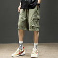 Men's olive cargo shorts with pockets, paired with graphic socks and sneakers for casual streetwear style