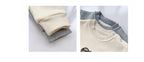Cream and gray baby long-sleeve onesies with ribbed cuffs and snap buttons, soft cotton fabric