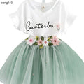 White V-neck kids dress with floral embroidery and mint tulle skirt, perfect for parties or casual wear