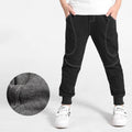 Boy wearing Ancient Energy boys' sports trousers, showing the athletic fit and breathable fabric in action.