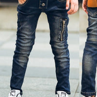 Boy wearing ancient energy stretch denim pants, casual kids' jeans with a comfortable fit and classic blue wash.