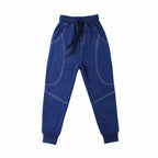 Young boy wearing Ancient Energy boys' sports trousers, athletic pants with a comfortable fit and sporty design.
