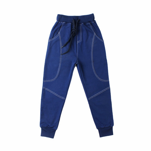 Young boy wearing Ancient Energy boys' sports trousers, athletic fit with adjustable waistband and breathable fabric.