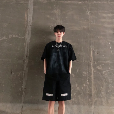 Man wearing Mandotos International black urban graffiti print tee and matching shorts.