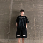 Man wearing Mandotos International black urban graffiti print tee and matching shorts.