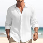 Man wearing a white plus size casual lapel shirt on a beach.