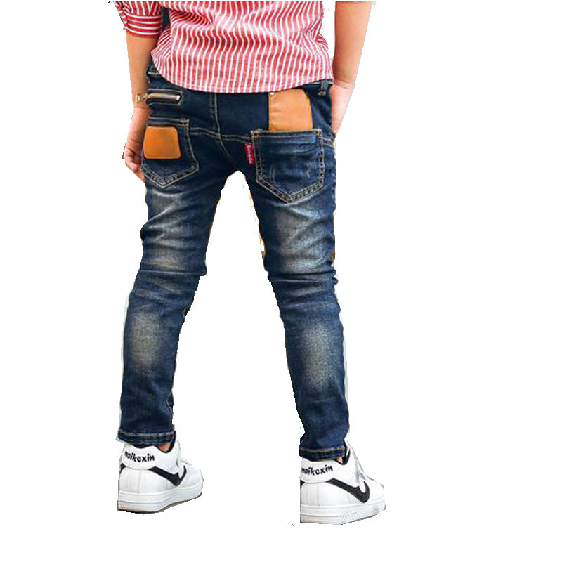 Young boy wearing blue stretch denim pants from Ancient Energy, casual style with comfortable fit and classic five-pocket design.